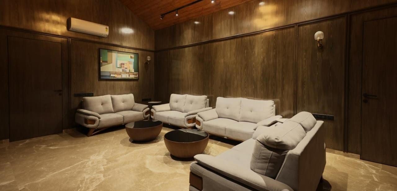 Warm, timber-clad living room of C8 Villa with a large sectional sofa under a timber ceiling.