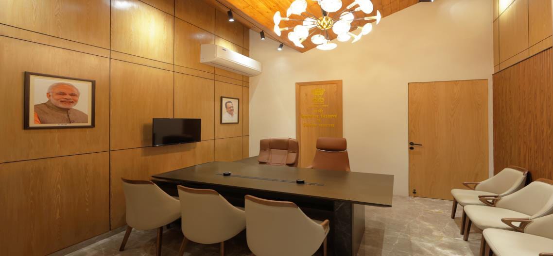 Dining area with wood-panelled walls, a dining table and framed artwork.