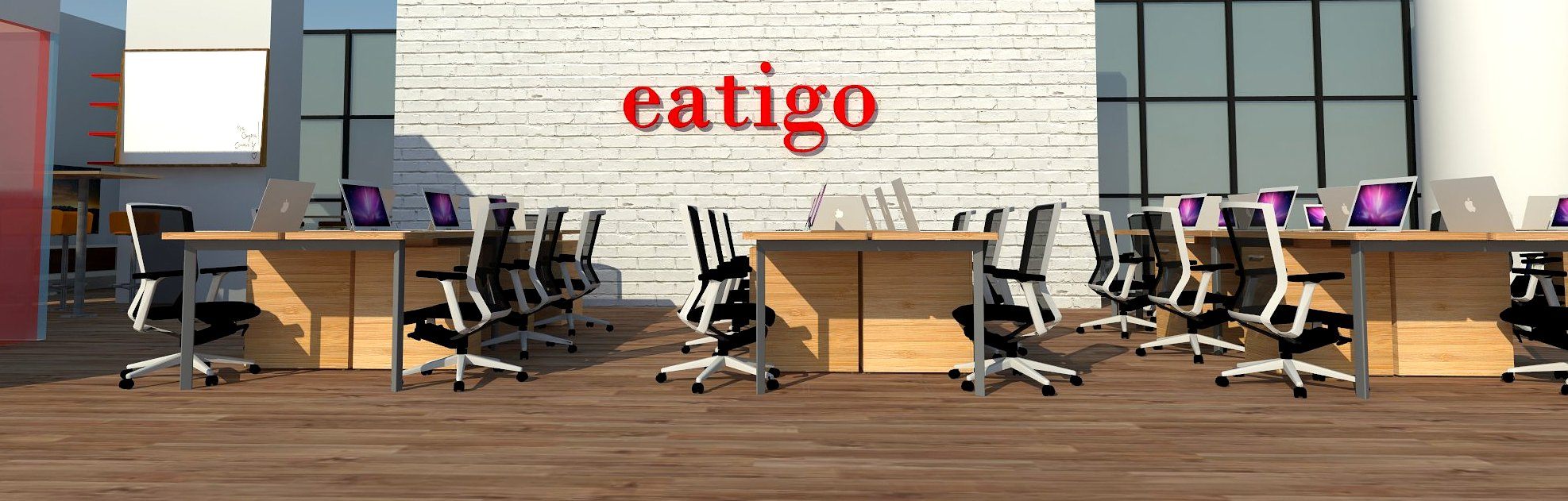 Frontal eye-level view of workstations against the eatigo logo wall