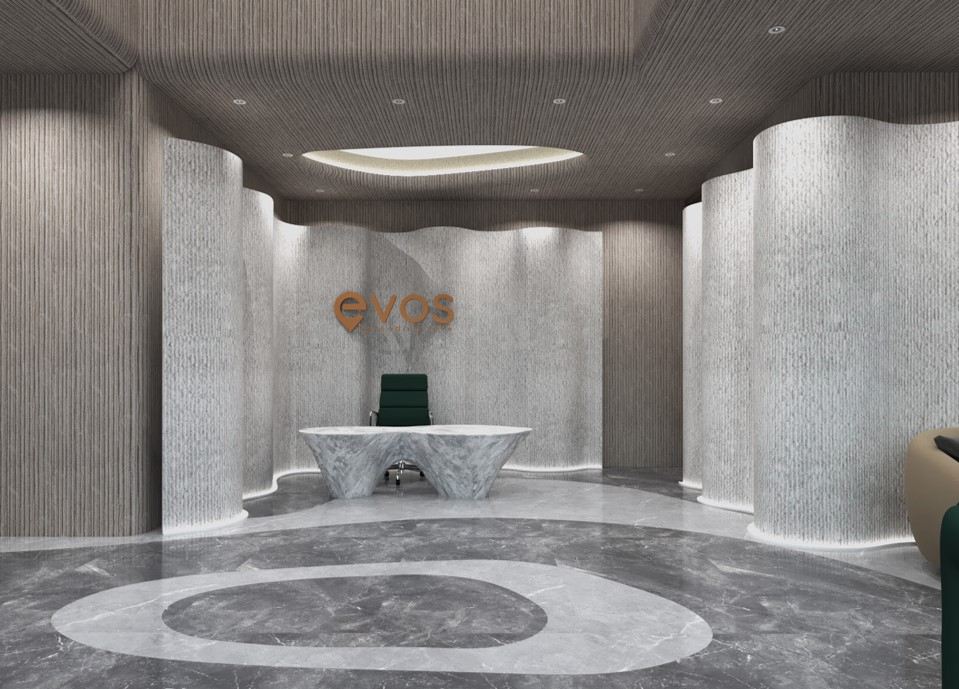 Glazed meeting room with timber table and green chairs, viewed between undulating fluted-stone columns over marble flooring.
