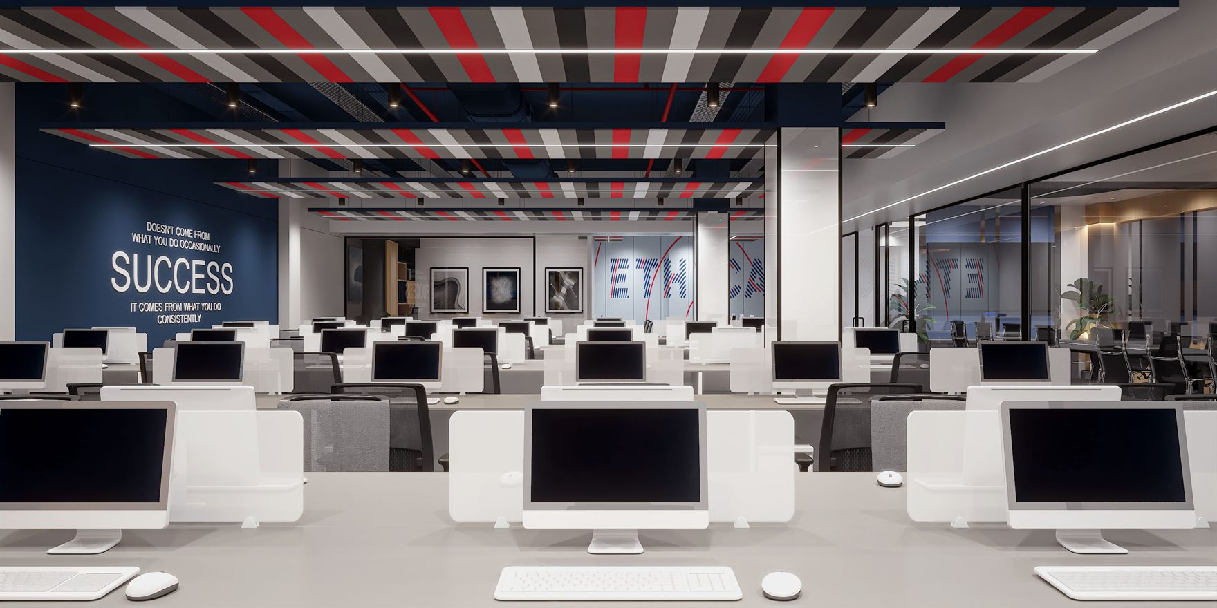 Open workstations with white desks and iMacs, a striped red-grey-white ceiling raft and a navy accent wall bearing large SUCCESS lettering