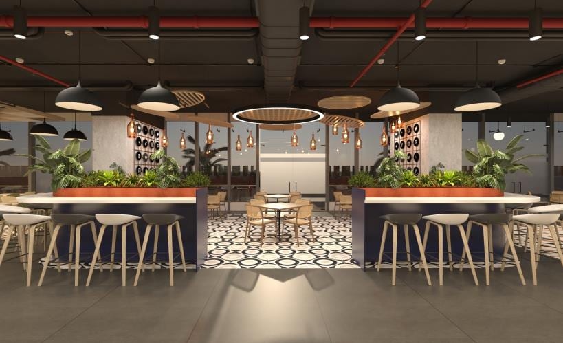 Hospitality-led co-working space at Rush Co-Works, Turbhe, with a cafe counter and communal seating.
