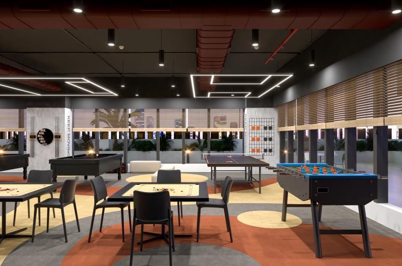Recreation lounge with a foosball table, casual seating and a wall of storage lockers.