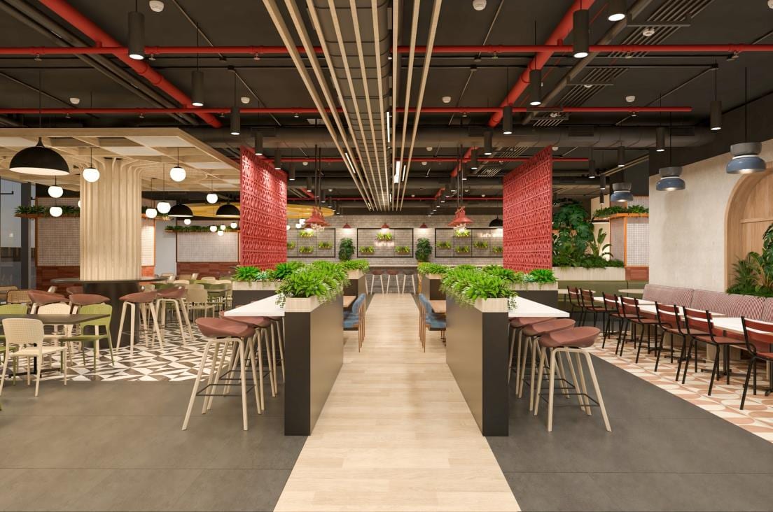 Food-court style seating hall with red columns, high communal tables and an exposed red ceiling grid.