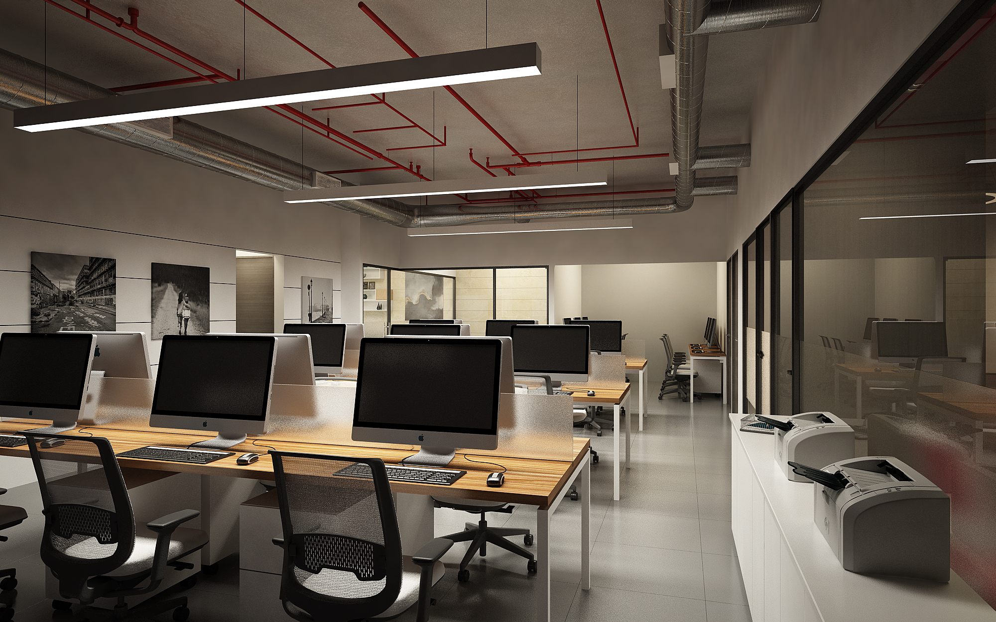 Industrial open office with timber-topped iMac benches, glazed cabins and signature exposed red services overhead.